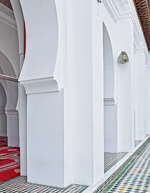 Arches and zellige tiles in a courtyard in Fès