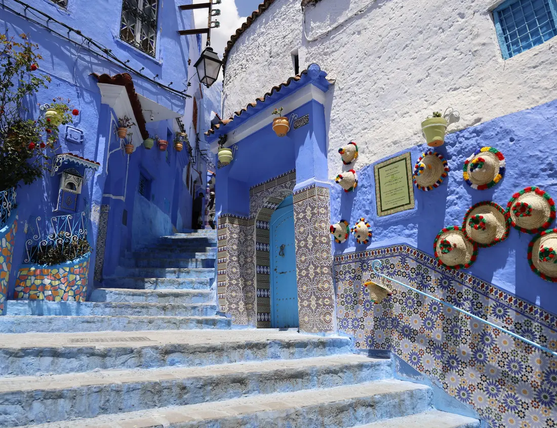 Blue stairs and flower pots in Chefchaouen